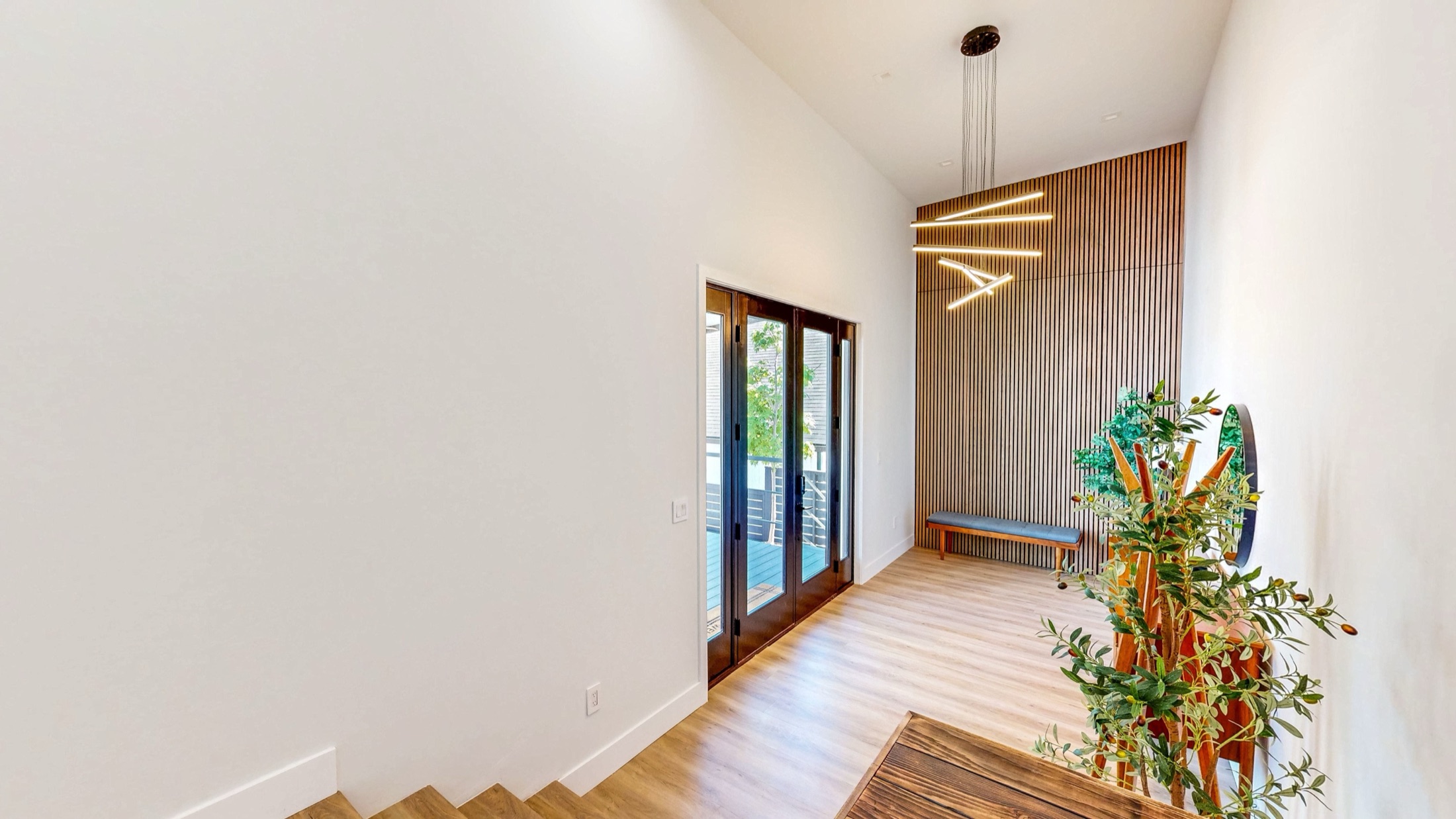Double-height entry with wood slat feature wall at 2828 Western Avenue, a Steve-represented remodel
